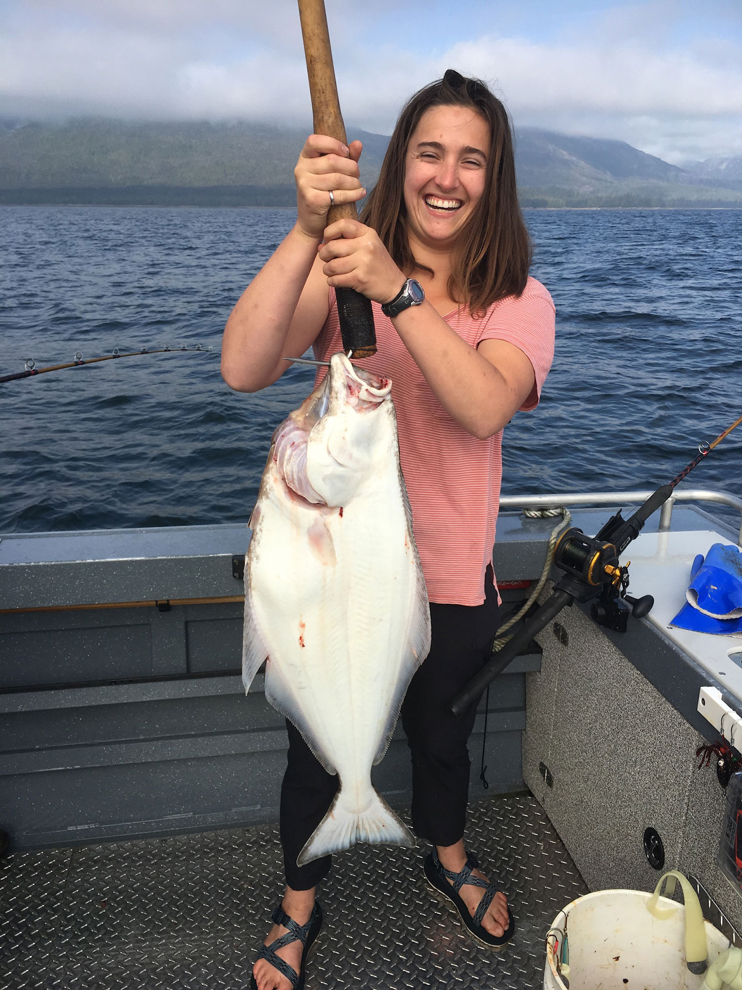 A woman holding a large fish caught on the Ketchikan fishing trip.