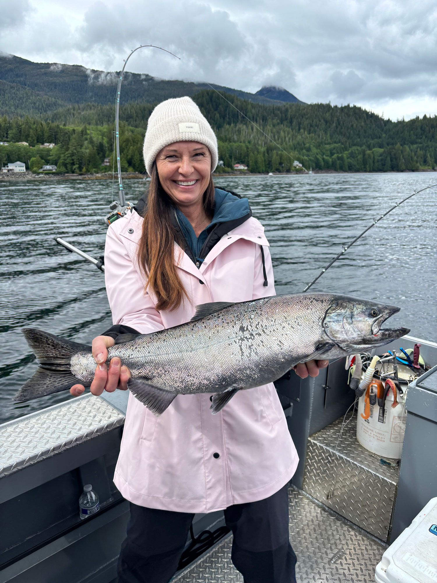 A client holding their Salmon catch on Ketchikan fishing charter in Alaska.